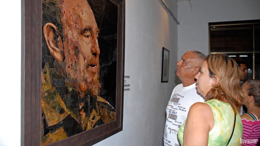 Personas admirando un cuadro de Fidel Castro