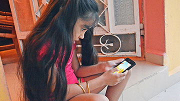 Niña juega con celular